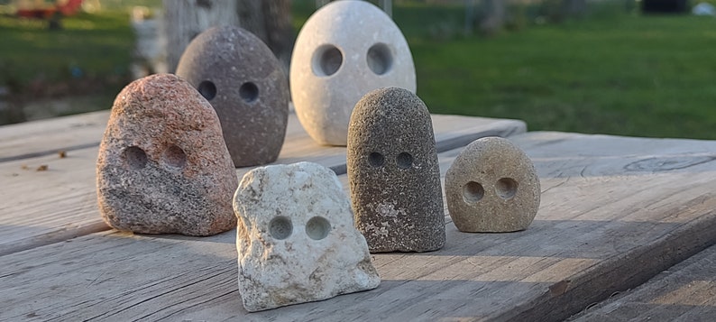 funny cute art rock set, grey and pink and white limestone, minimalist eye holes excavated with high speed drill