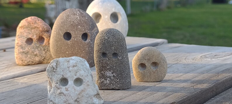 funny cute art rock set, grey and pink and white limestone, minimalist eye holes excavated with high speed drill