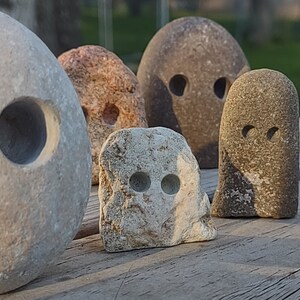 funny cute art rock set, grey and pink and white limestone, minimalist eye holes excavated with high speed drill