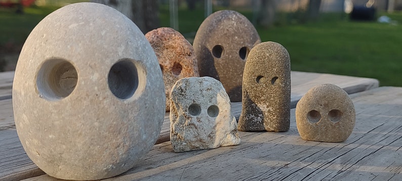 funny cute art rock set, grey and pink and white limestone, minimalist eye holes excavated with high speed drill