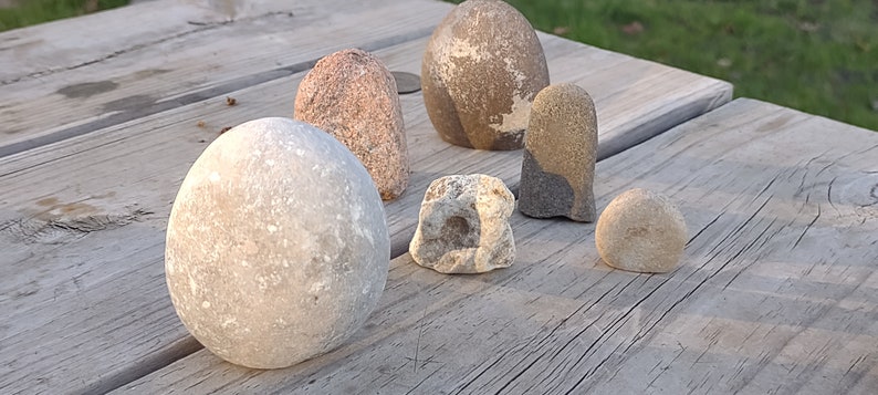 funny cute art rock set, grey and pink and white limestone, minimalist eye holes excavated with high speed drill