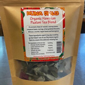 May include: A brown paper bag with a clear window showing a blend of dried herbs and leaves. The bag is labeled "PUNA GOLD Organic Hawaiian Pualani Tea Blend". The text on the bag describes the tea as an aromatic blend of mamaki, soursop leaves, cinnamon leaves, moringa, dried gardenia blossoms, hibiscus, coconut, loquat leaves and lemongrass. The text also states that the ingredients spent long days soaking up the Hawai'i sun on our Big island organic farm to create this delicious relaxing tea.
