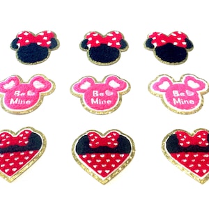 May include: Ten iron-on patches featuring a red and white polka dot bow, black ears, and a pink heart with the text "Be Mine". Some patches are shaped like a heart, while others are shaped like a mouse head.