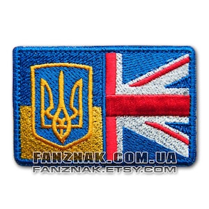 May include: Embroidered patch featuring the flags of Ukraine and the United Kingdom. The Ukrainian flag is on the left side of the patch and features a blue field with a yellow trident. The British flag is on the right side of the patch and features a red cross on a white field, with a blue background.