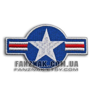 May include: Embroidered patch with a white star inside a blue circle and horizontal bars with red and white stripes. The patch has the text "FANZNAK.COM.UA" and "FANZNAK.ETSY.COM" in white.