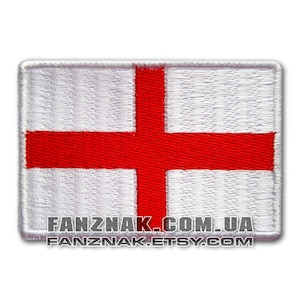 May include: Embroidered patch depicting the flag of England, a white rectangle with a red cross. The patch has a white border and the text "FANZNAK.COM.UA" and "FANZNAK.ETSY.COM" at the bottom.