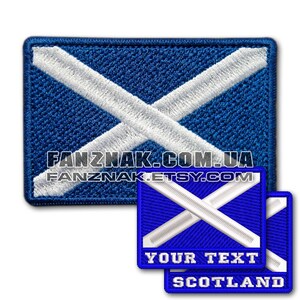 May include: Two embroidered patches featuring the Scottish flag, a blue background with a white diagonal cross. The first patch is larger and has the text "FANZNAK.COM.UA FANZNAK.ETSY.COM". The second patch is smaller and has the text "YOUR TEXT SCOTLAND".