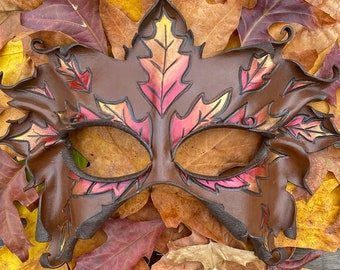 Autumn greenman leather leaf mask with brown maple and oak leaves in fall colors. Woodland style fantasy costume for ren faire or masquerade
