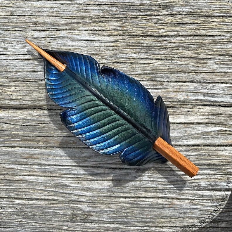 Raven feather ponytail holder with wood stick. Small tooled leather shawl pin in black w/ iridescent blues and greens. Gift for corvid lover 4.5" amber stick