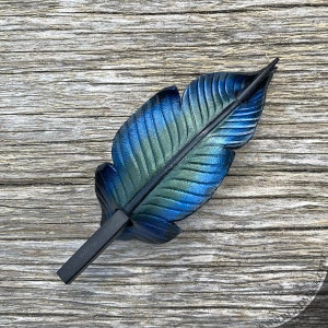 Raven feather ponytail holder with wood stick. Small tooled leather shawl pin in black w/ iridescent blues and greens. Gift for corvid lover 4.5" black stick