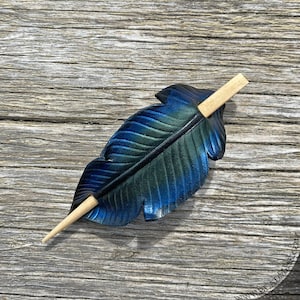 Raven feather ponytail holder with wood stick. Small tooled leather shawl pin in black w/ iridescent blues and greens. Gift for corvid lover 4.75" blonde stick