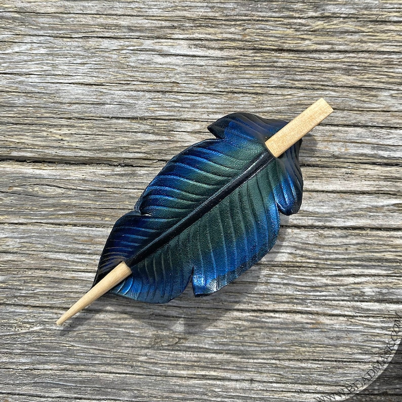 Raven feather ponytail holder with wood stick. Small tooled leather shawl pin in black w/ iridescent blues and greens. Gift for corvid lover 4.75" blonde stick