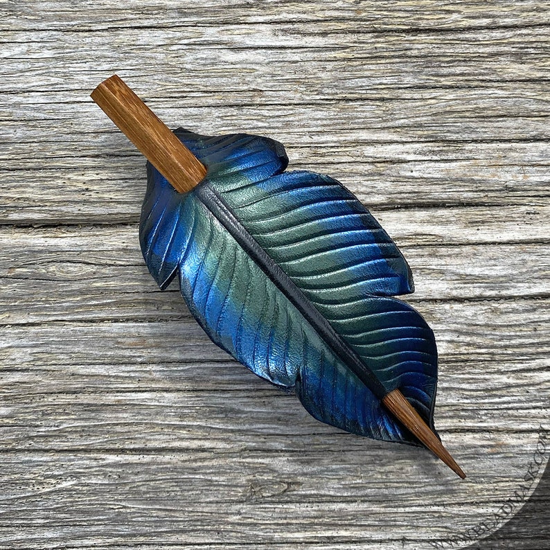 Raven feather ponytail holder with wood stick. Small tooled leather shawl pin in black w/ iridescent blues and greens. Gift for corvid lover 4.5" brown stick