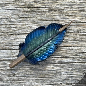 Raven feather ponytail holder with wood stick. Small tooled leather shawl pin in black w/ iridescent blues and greens. Gift for corvid lover 4.5" grey stick