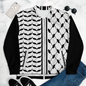 May include: A black and white bomber jacket with a geometric pattern. The jacket has a zipper closure and two pockets.