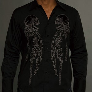 May include: A black long-sleeved button-down shirt with a skull and chain design embroidered on the front.