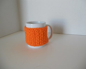 Orange crochet cup cozy with a button, crochet mug cozy