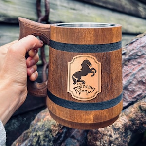 May include: A wooden beer stein with a stainless steel liner and a black leather patch with the text "The Prancing Pony" and a silhouette of a horse.