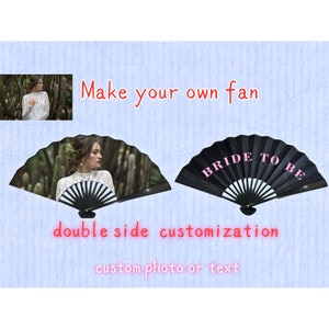 May include: Two black folding fans with white accents. One fan has a photo of a woman in a white dress, the other fan has the text "Bride to Be" in pink letters.