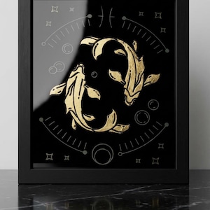May include: Framed art print featuring a gold illustration of two koi fish in a yin-yang arrangement against a black background. The artwork includes geometric shapes and lines, all within a black frame.