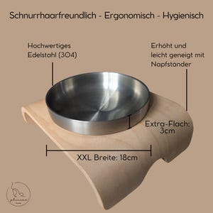 May include: A wooden pet food bowl stand with a stainless steel bowl. The stand is elevated and angled slightly. The bowl is 3 cm high and the stand is 18 cm wide. The stand is made of natural wood and has a smooth finish. The bowl is made of high-quality stainless steel and is dishwasher safe.