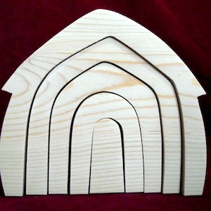 May include: A set of five unfinished wooden arches, stacked in a graduated size, resembling a barn or house shape. The arches are made of natural wood and have a smooth, sanded finish.