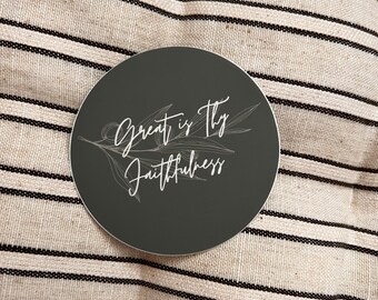 May include: A black and white round sticker with the text "Great is Thy Faithfulness" and a stylized olive branch design.