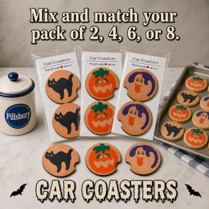 May include: Round car coasters featuring Halloween designs of black cats, orange pumpkins, and purple ghosts. The coasters are packaged in clear sleeves with labels reading Car Coasters Handmade with love. Text at the top reads Mix and match your pack of 2, 4, 6, or 8.