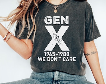 May include: A dark gray t-shirt with a white graphic that says "GEN X 1965-1980 WE DON'T CARE".