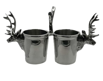 May include: A set of three ceramic mugs with a speckled, matte finish. The mugs are in shades of cream, gray, and black. Each mug has a simple, minimalist design, suitable for coffee or tea. The mugs are stacked on top of each other.