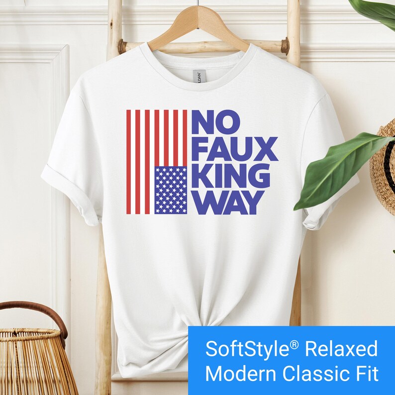 White t-shirt with an inverted "in distress" American flag hanging vertically next to large text reading "No Faux King Way."