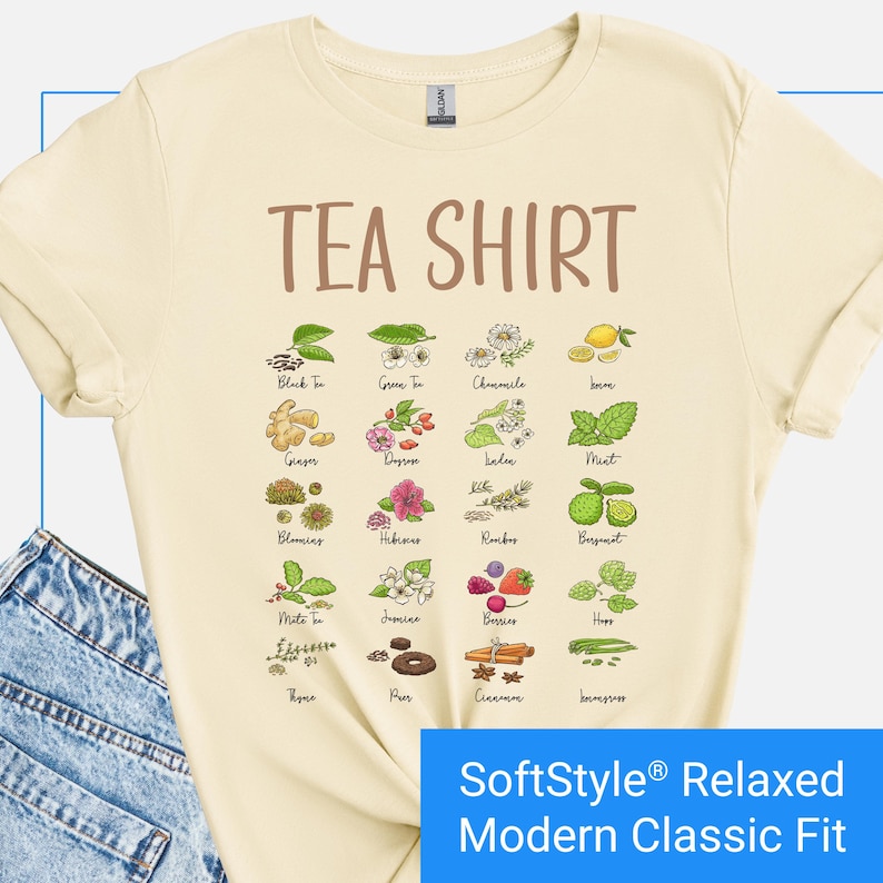 Cream color t-shirt featuring a colorful illustrated grid of tea ingredients like mint, ginger, chamomile, and berries with large text that reads “Tea Shirt” at the top in brown lettering.