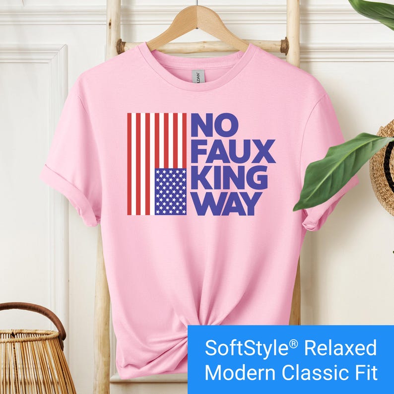 Light pink t-shirt with an inverted "in distress" American flag hanging vertically next to large text reading "No Faux King Way."
