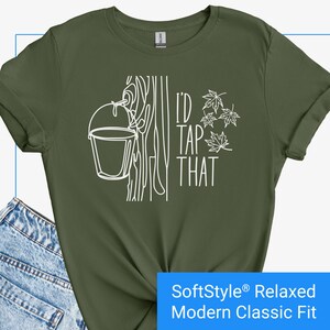 May include: Green t-shirt with a white graphic of a maple tree with a bucket hanging from it. The text "I'd Tap That" is written on the shirt.