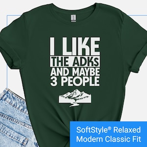 May include: Dark green t-shirt with white text that reads "I LIKE THE ADKS AND MAYBE 3 PEOPLE." A mountain and river graphic is below the text. The shirt is a SoftStyle® Relaxed Modern Classic Fit.