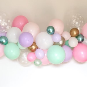 May include: A collection of pastel-colored balloons in pink, mint green, lavender, white, and gold. Some balloons are clear with white star patterns. The balloons vary in size and are clustered together, creating a festive display.