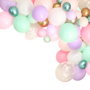 May include: A collection of pastel-colored balloons in shades of pink, purple, mint green, white, and gold. The balloons vary in size and are arranged in a curved shape, creating a festive and celebratory atmosphere. Some balloons have a star pattern.