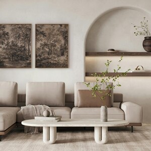 May include: A light beige sectional sofa with a brown throw blanket and a white marble coffee table with a unique curved base. The sofa is in a living room with a white wall and a niche with shelves and a vase with dried branches.