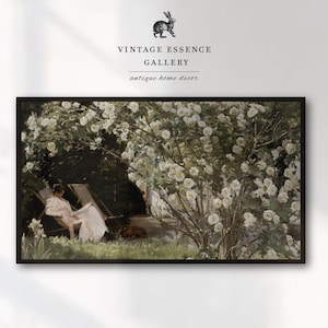 May include: A vintage framed print of a woman sitting in a chair under a blooming white flower bush. The print is titled "Vintage Essence Gallery, antique home decor".