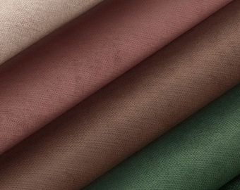 Op de afbeelding: Close-up van stofstalen in verschillende tinten bruin, beige en groen. De stof heeft een zacht, getextureerd oppervlak.