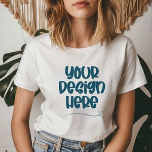 May include: White t-shirt with short sleeves featuring the text "your design here" in blue lettering with a small heart.