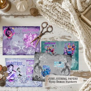 May include: A selection of Junk Journal Papers with Kpop Demon Hunters designs. The papers display vibrant anime-style illustrations, musical notes, and the text "HUNTRIX". They are arranged on a white wooden surface, alongside decorative items.