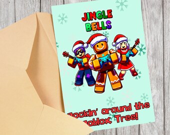 May include: A Christmas card with the words "Jingle Bells" in red, green, and purple. The card features three gingerbread-like characters wearing Santa hats and playing guitars. The text "Rockin' around the Roblox Tree!" is at the bottom. The card is inside a tan envelope.