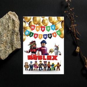 May include: A birthday card featuring Roblox characters and a "Happy Birthday" banner against a backdrop of gold balloons. The word "ROBLOX" is prominently displayed in red. A festive and colorful design.