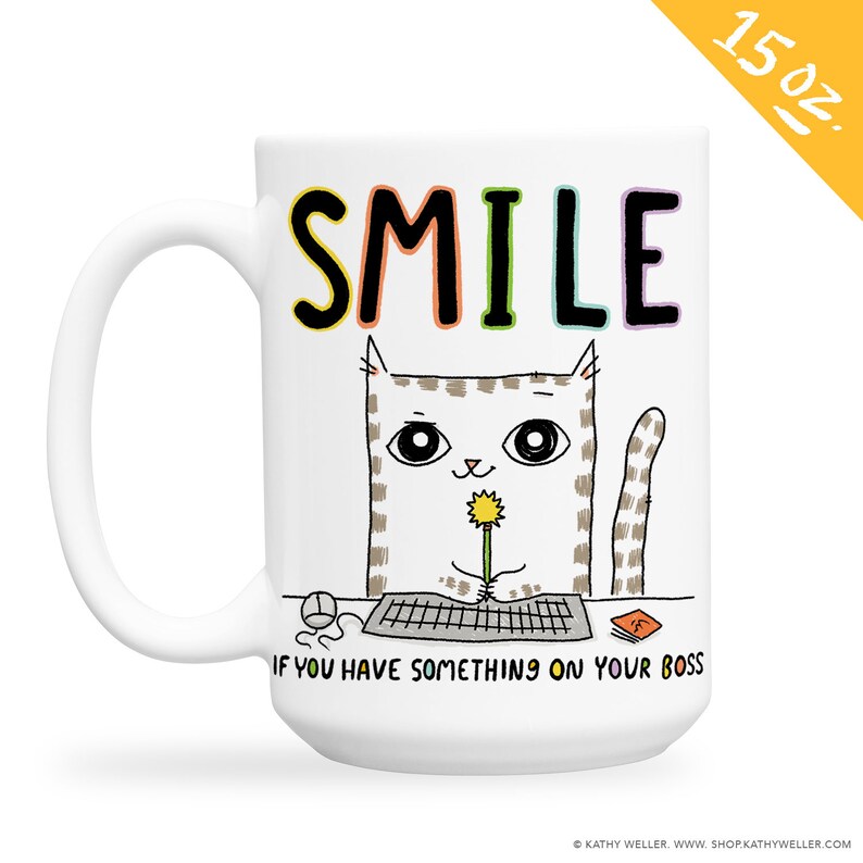 May include: White ceramic mug with a colorful "SMILE" graphic and a cartoon cat holding a flower. The text below the cat reads "IF YOU HAVE SOMETHING ON YOUR BOSS".