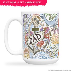 May include: White ceramic mug with a blue and green illustration of an anchor with the word "DAD" and the text "My Anchor" on a banner. The illustration also includes a whale, fish, coral, and other nautical elements. The mug is 15 ounces.