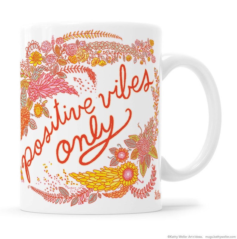 May include: White ceramic mug with a floral design in shades of pink, yellow, and orange. The text "positive vibes only" is written in red cursive.