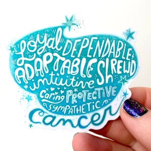 May include: A teal and white sticker with the word "Cancer" at the bottom. The sticker features the words "Loyal, Dependable, Adaptable, Shrewd, Intuitive, Caring, Protective, Sympathetic" in a whimsical font. Small stars and hearts decorate the design.