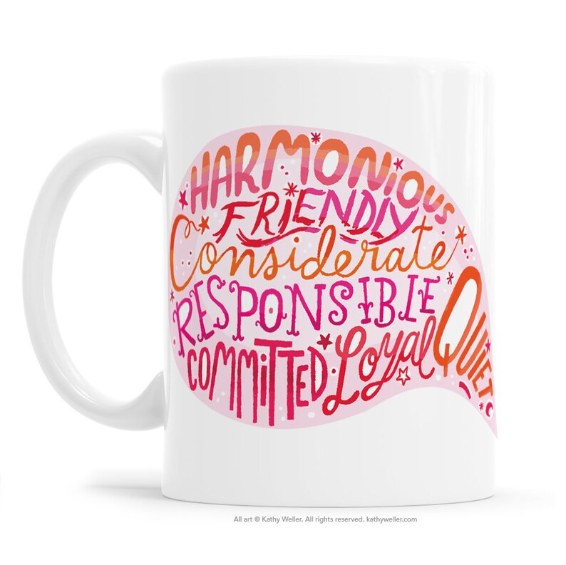 May include: White ceramic mug with a pink and red design. The design features the words "Harmonious", "Friendly", "Considerate", "Responsible", "Committed", "Loyal", and "Quiet".