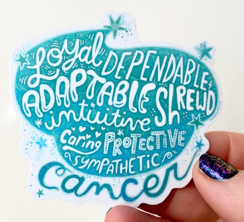 May include: A teal and white sticker with the word "Cancer" at the bottom. The sticker features the words "Loyal, Dependable, Adaptable, Shrewd, Intuitive, Caring, Protective, Sympathetic" in a whimsical font, with star and heart accents.